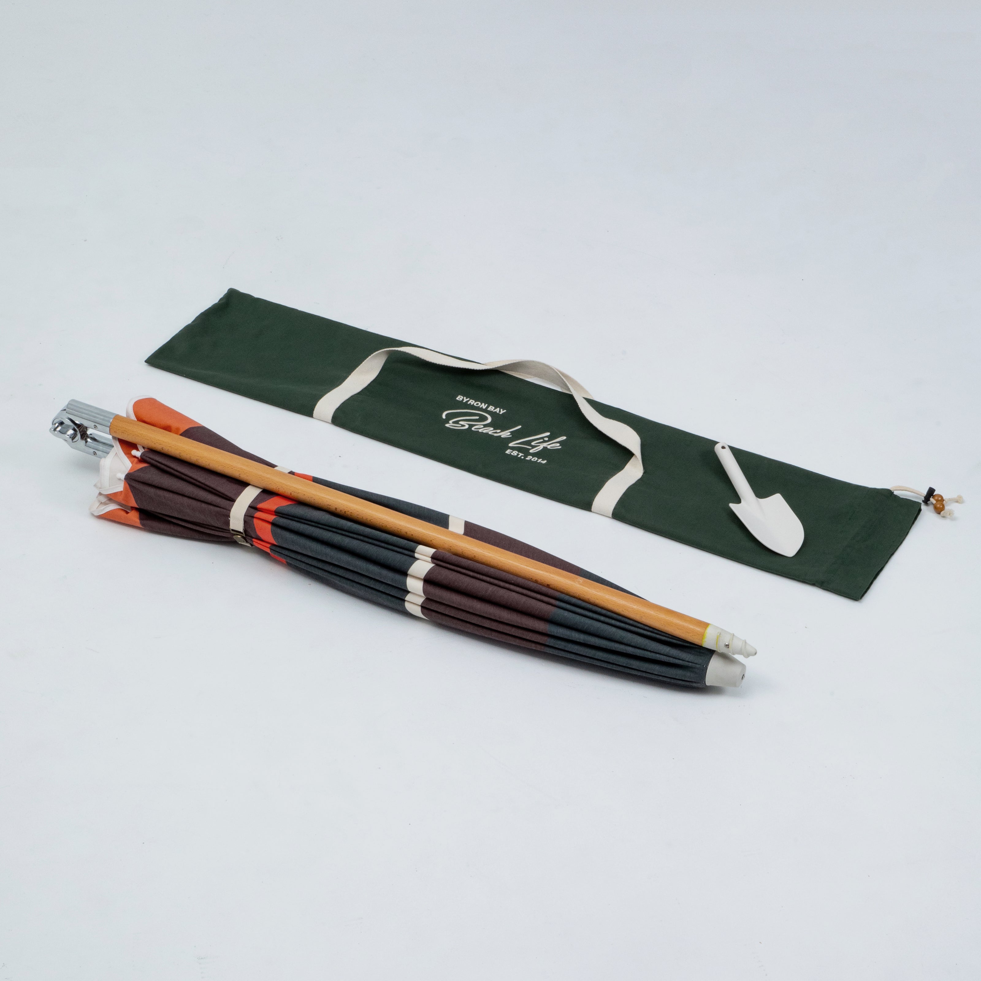 Beach Umbrella Folded with a green carrying bag on a white background