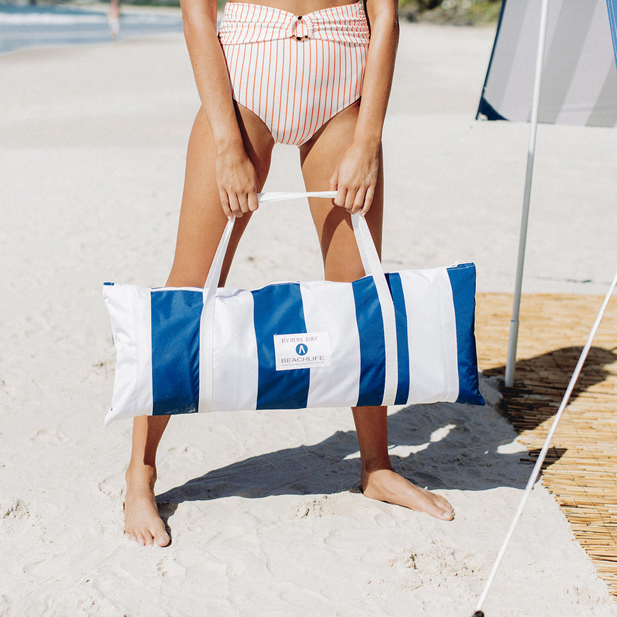 Beach Tent in Nautical Blue and White Stripe set up on Beach.  Beach Shade in Sun on sand.