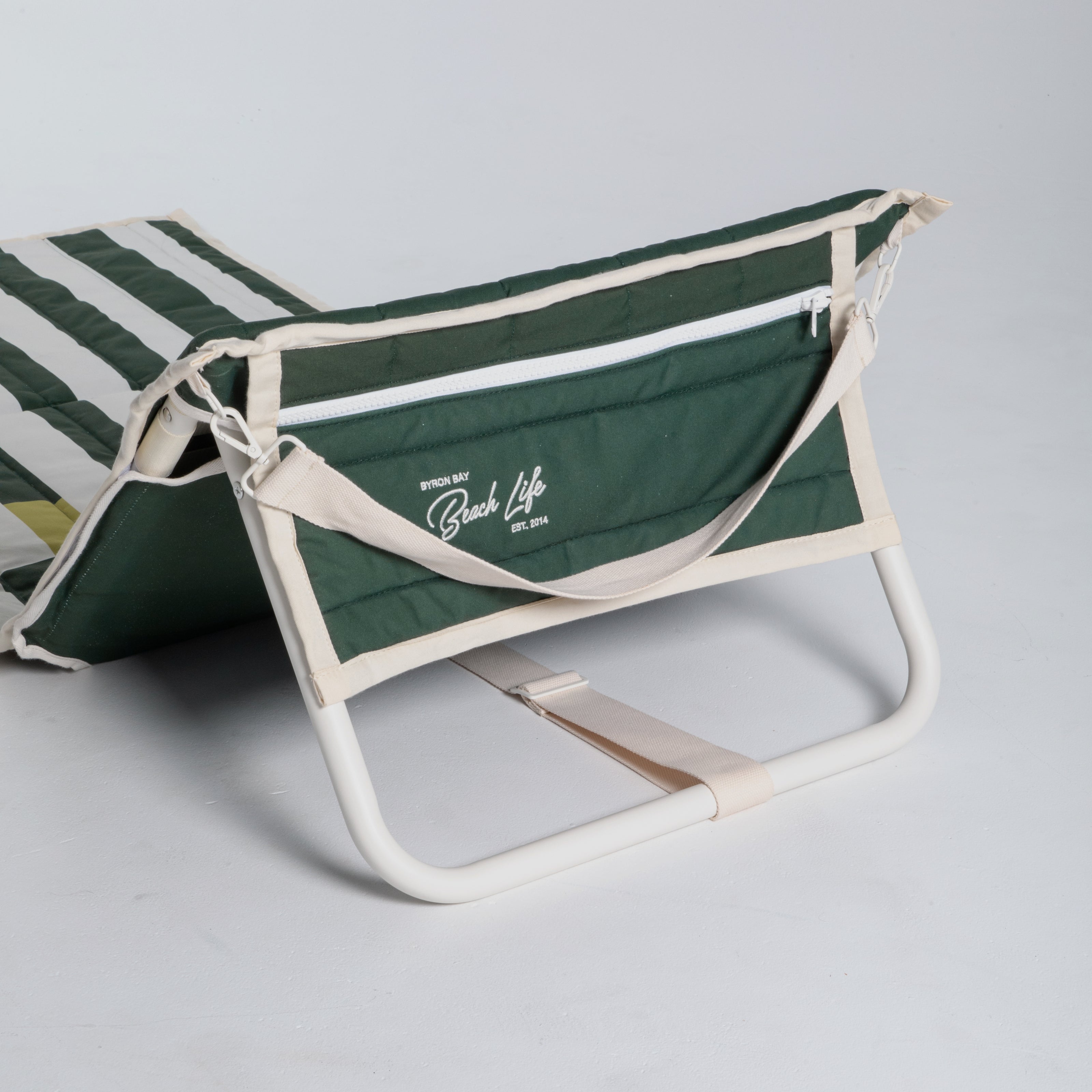 Green and white striped beach chair with 'Beach Life' branding on a light gray background